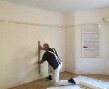 Room being measured for wallpaper In Wrexham